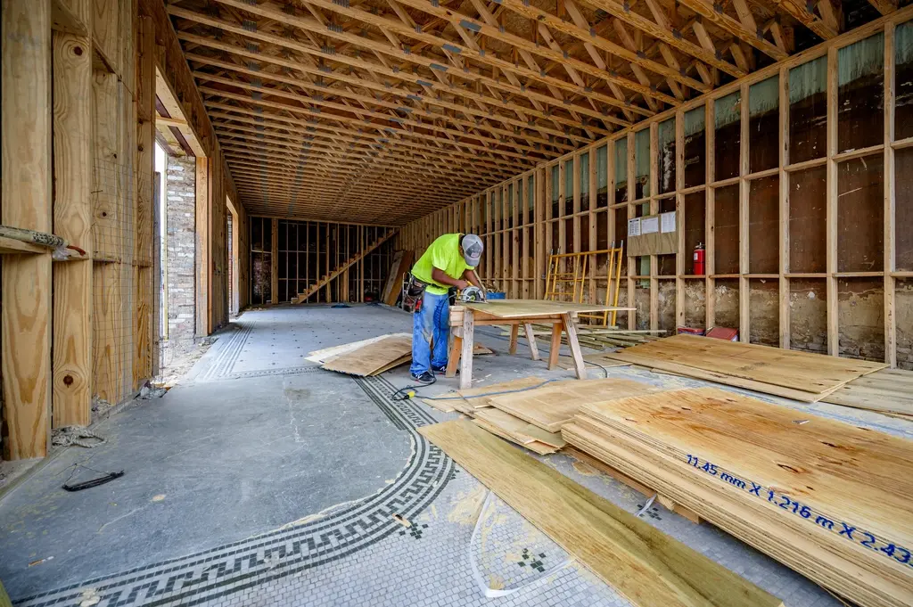 Long open interior with new wall framing during a renovation